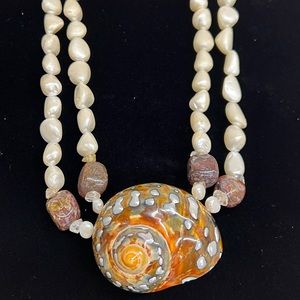 Meg Carter pearl and stone necklace with an African Turbo Seashell feature.